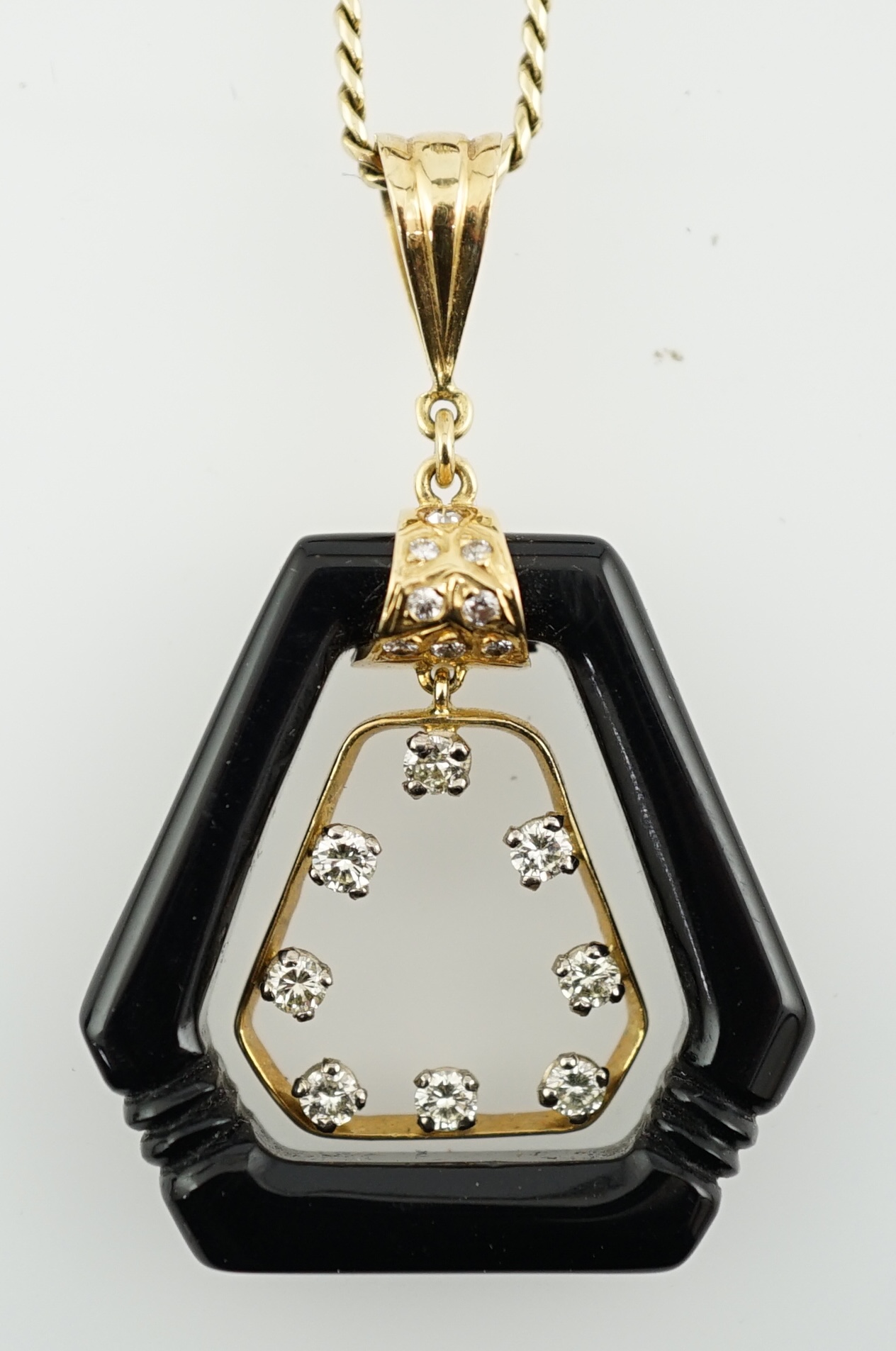 An Art Deco 18ct gold mounted black onyx and diamond set openwork drop pendant